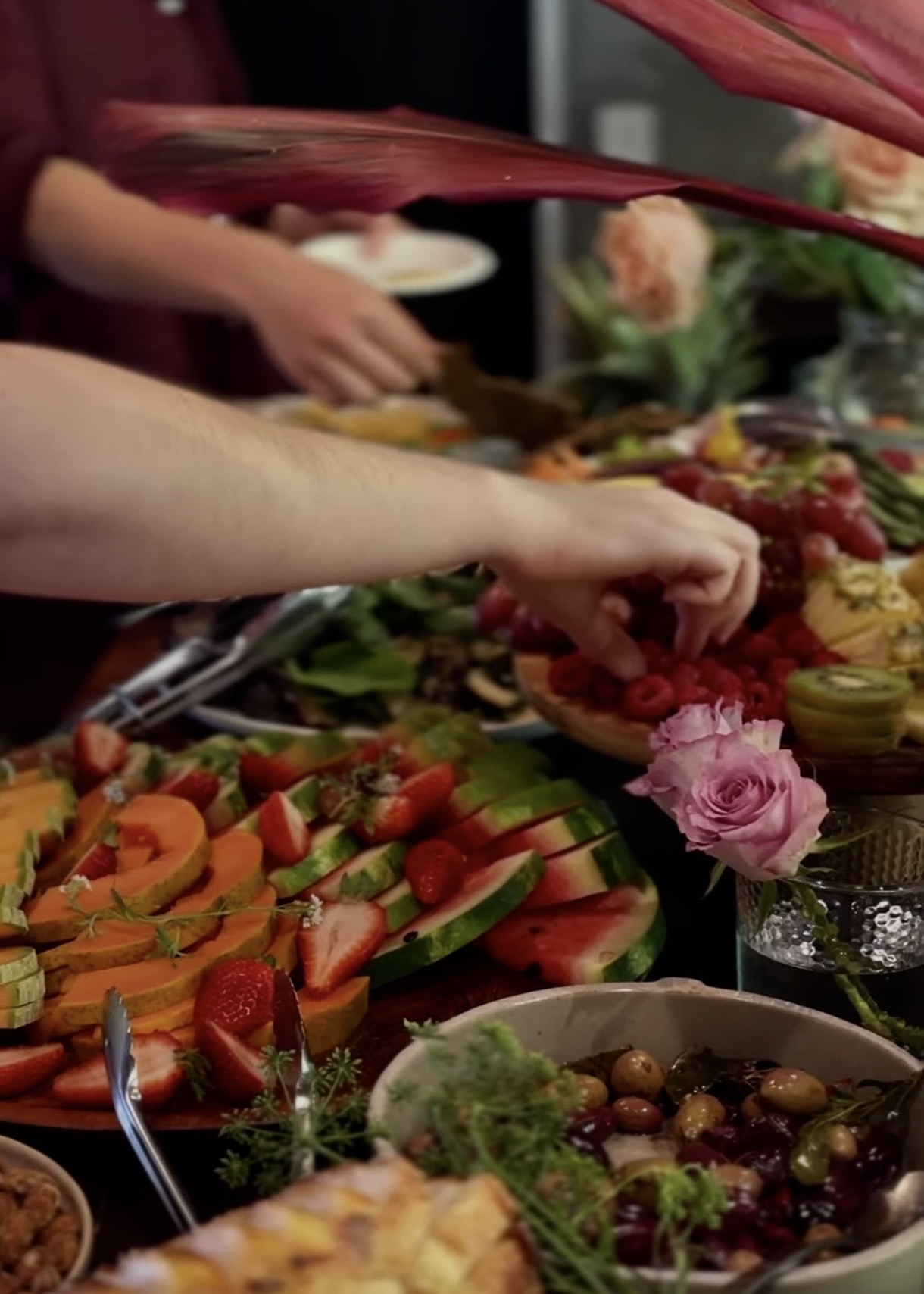 Shared grazing table of fresh fruit and flowers