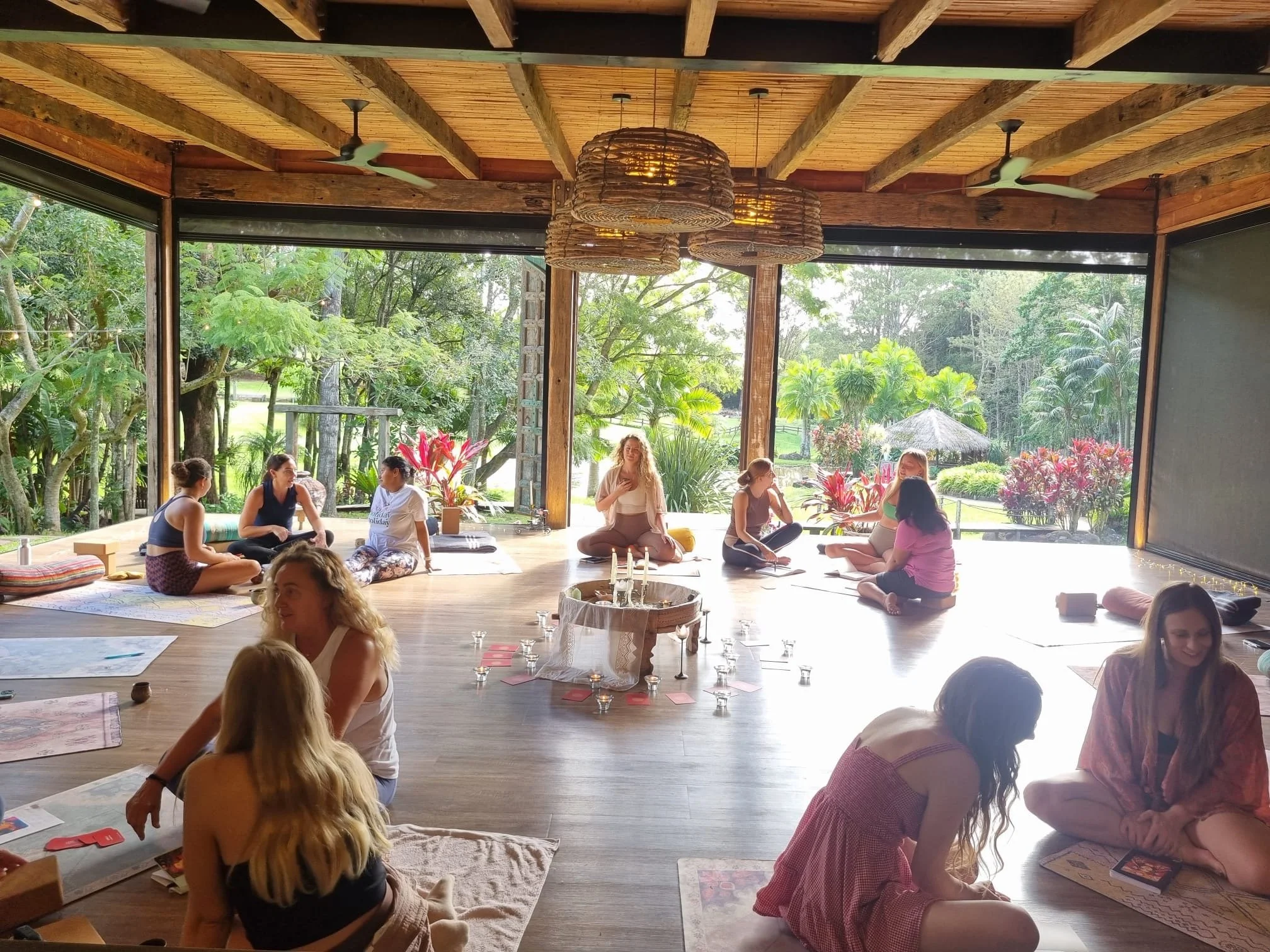Women sitting together in a nature-immersed retreat circle