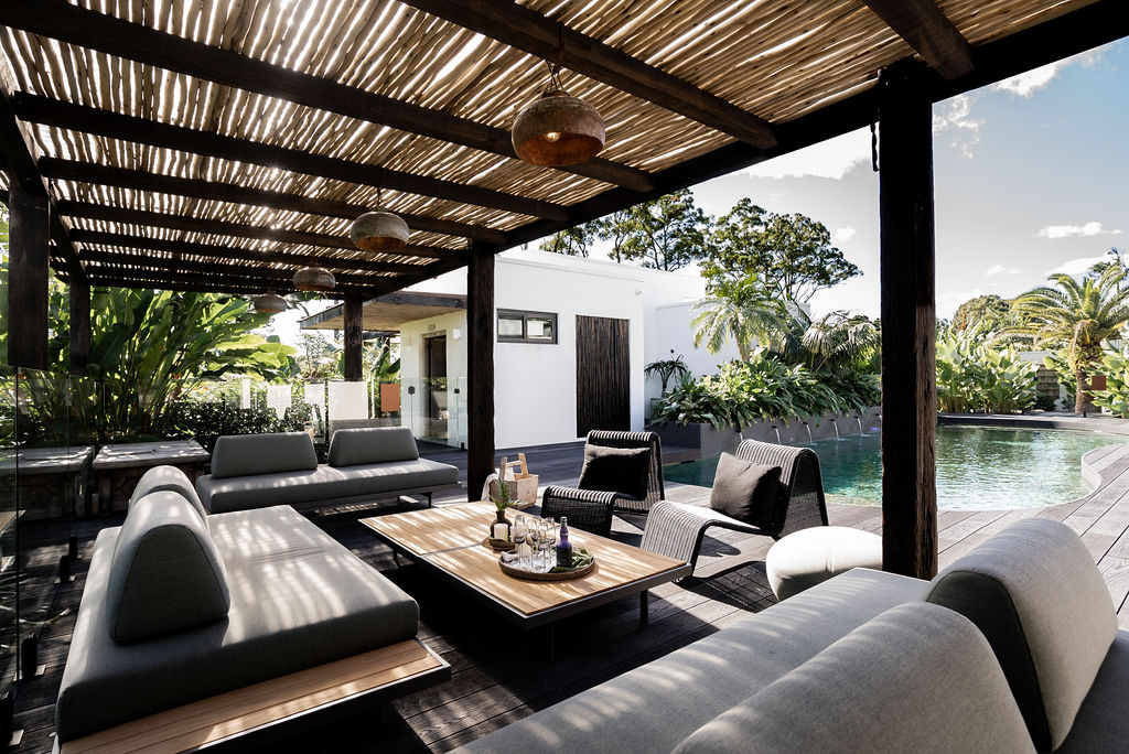 Poolside cabana lounge under the timber pergola