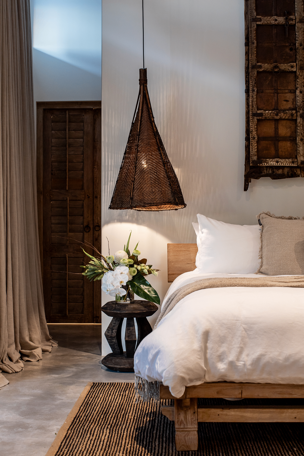 Suite with woven rattan pendant and timber bedhead
